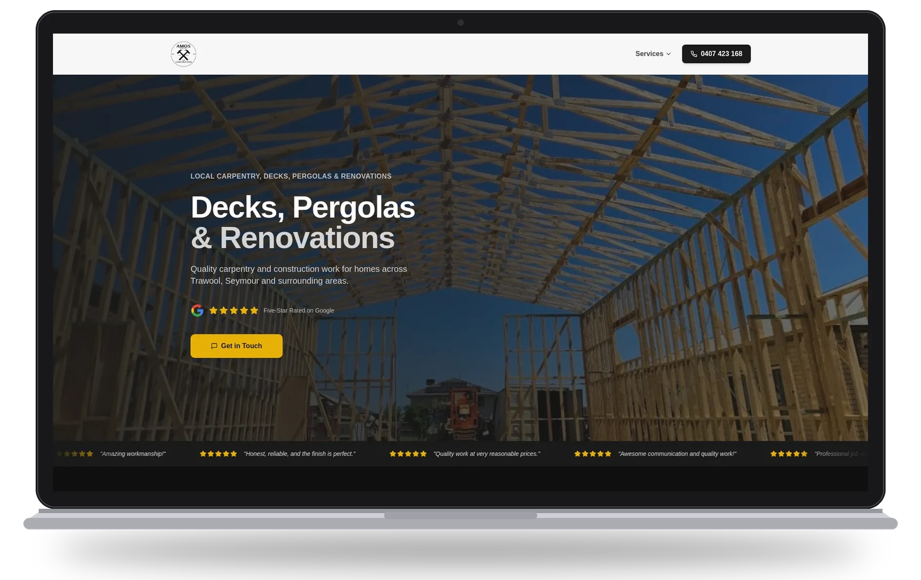 Amos Building & Construction website shown on a laptop