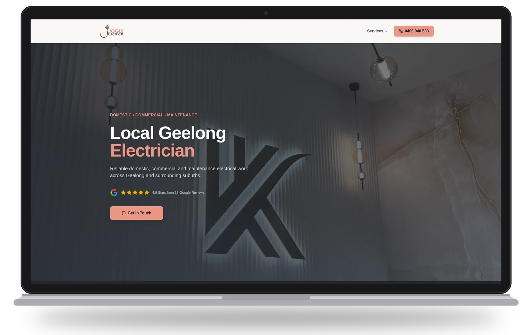 Jogle Electrical website shown on a laptop